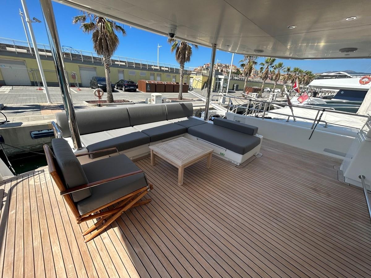 a deck with a couch and a pool aboard YES Yacht for Sale