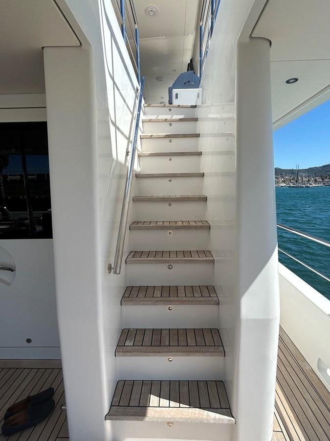 a white staircase with a railing aboard YES Yacht for Sale