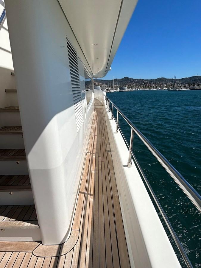 a long white boat on a body of water aboard YES Yacht for Sale