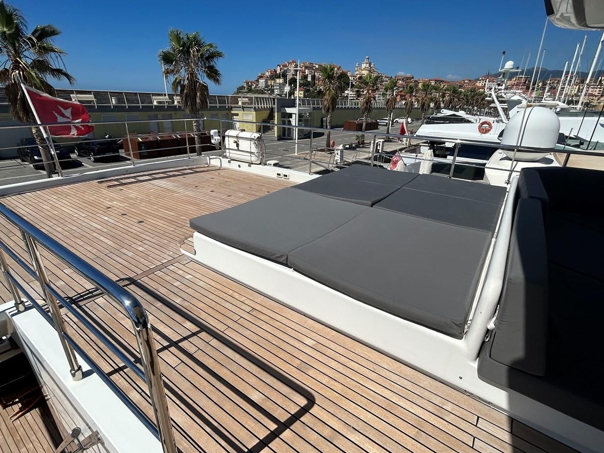 a deck with a boat and a deck with a building and trees aboard YES Yacht for Sale