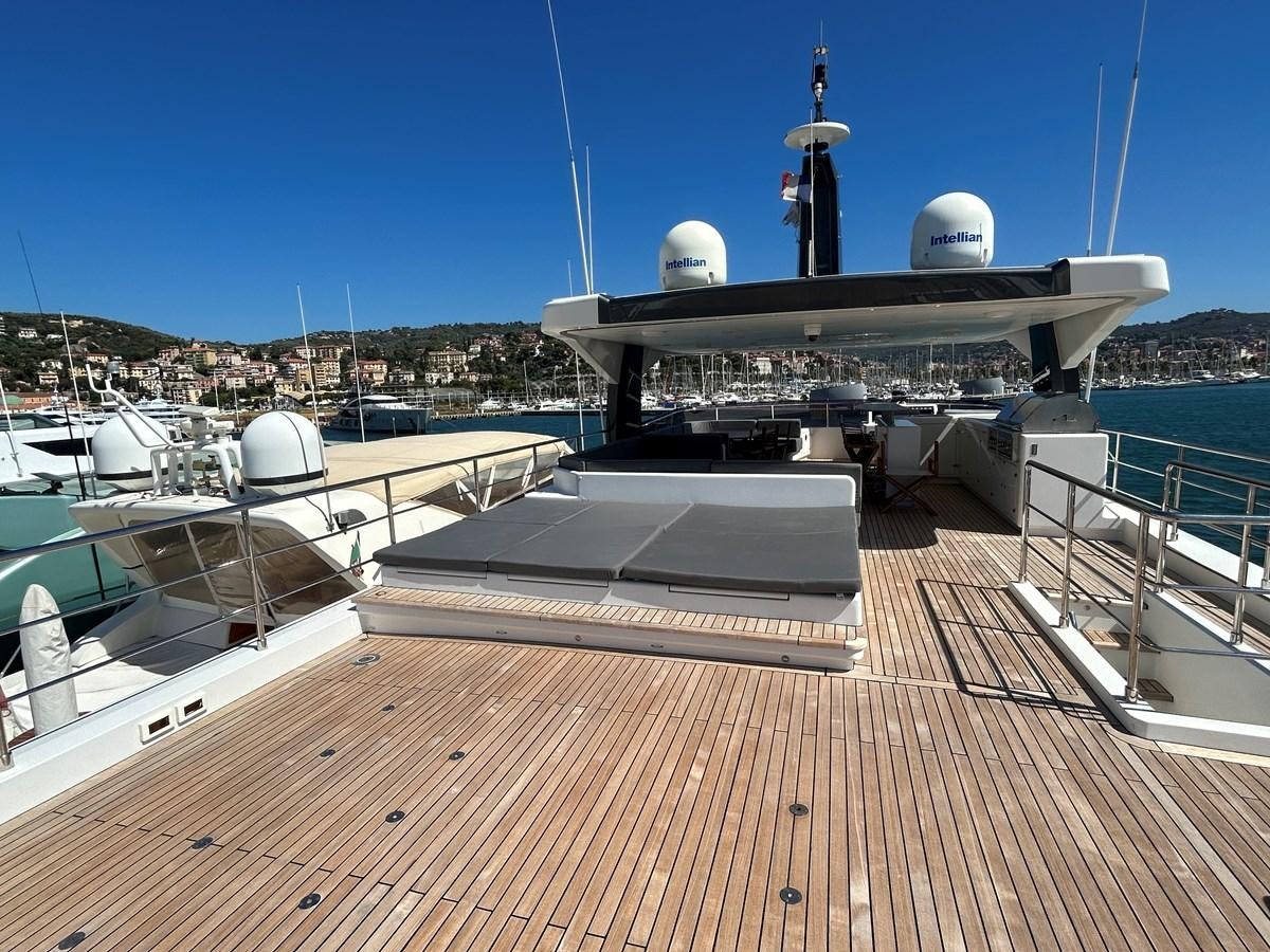 a deck with a large ship in the water aboard YES Yacht for Sale