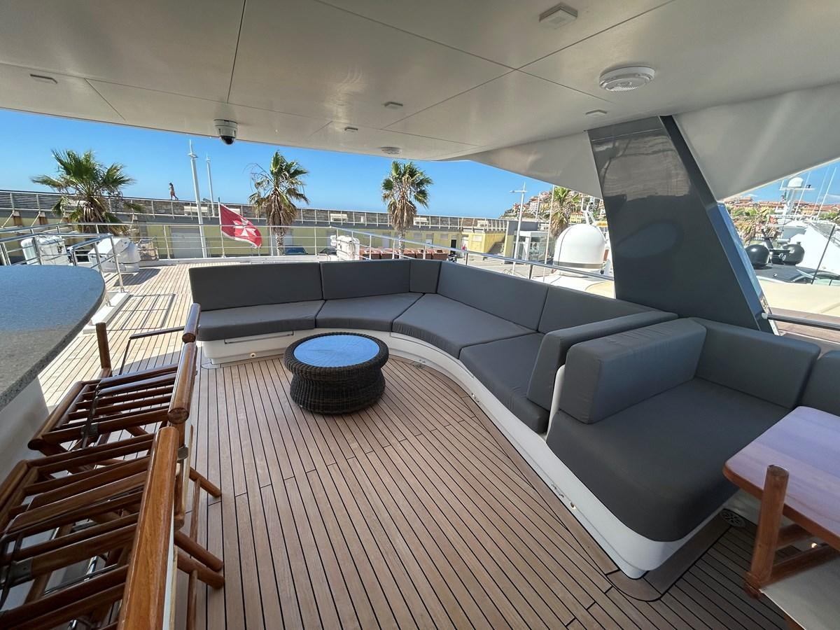 a deck with a couch and a pool aboard YES Yacht for Sale