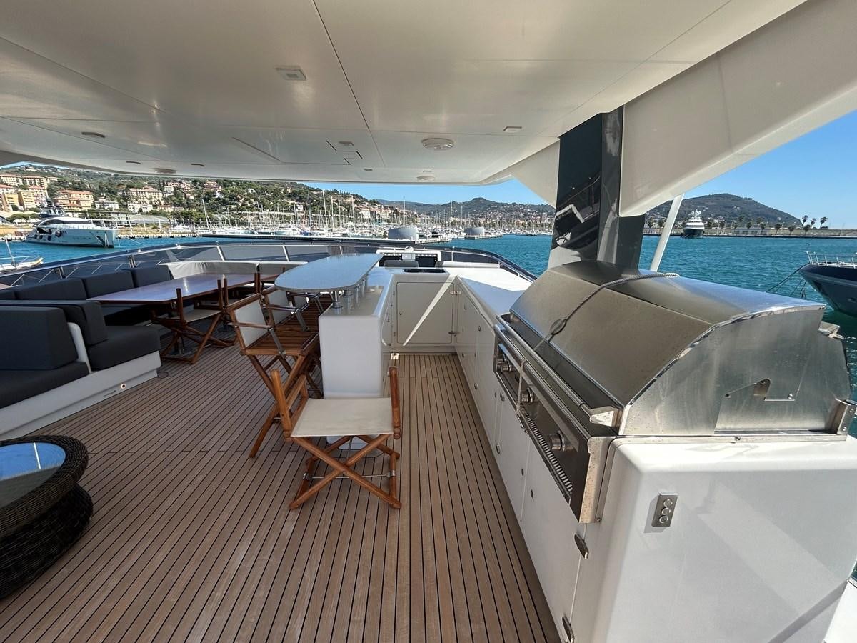 a deck with a deck and a view of a city aboard YES Yacht for Sale