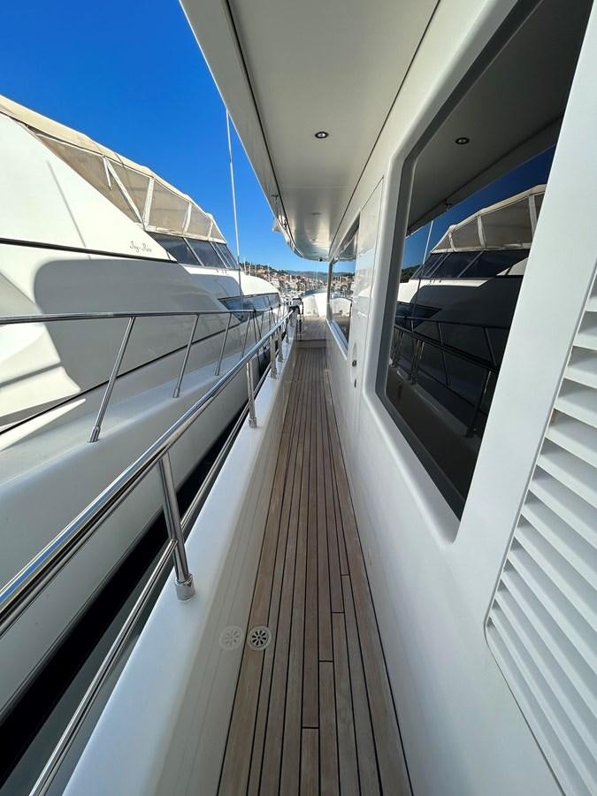 a deck with a railing aboard YES Yacht for Sale