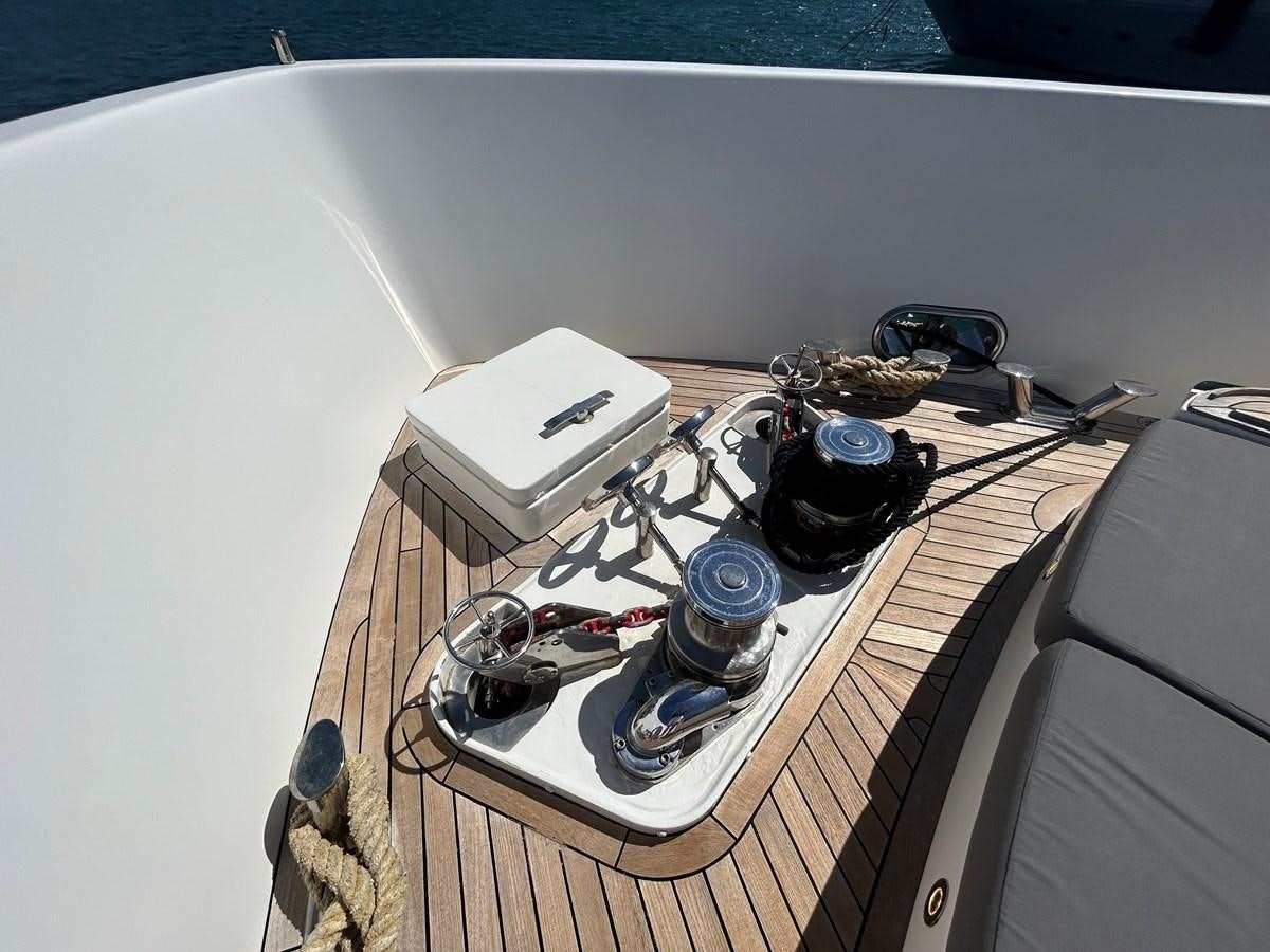 a table with a white tablecloth and a white box with a black object on it aboard YES Yacht for Sale