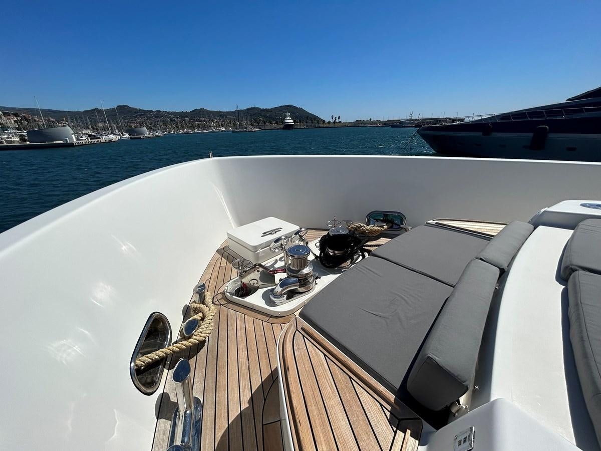 a deck with a boat and a laptop on it aboard YES Yacht for Sale