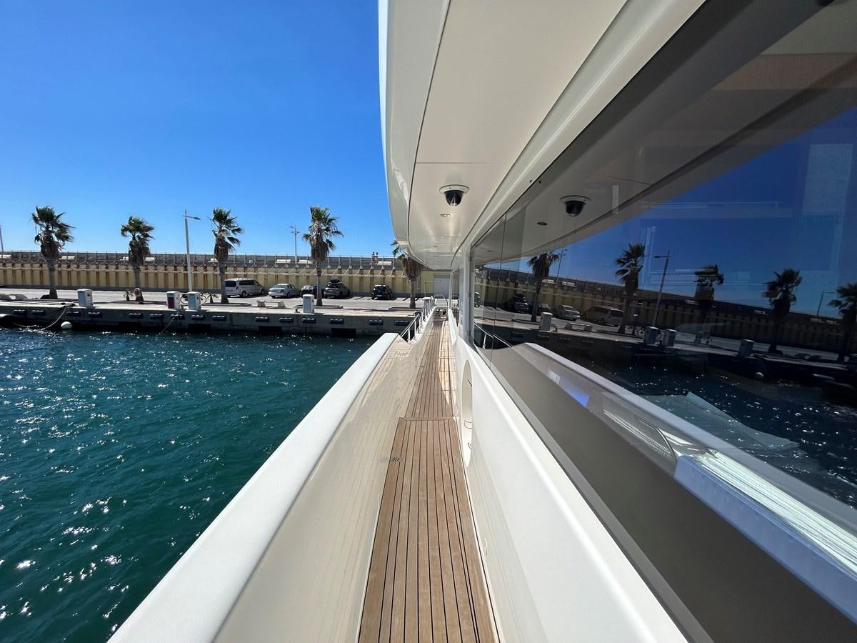 a long wooden dock over a body of water aboard YES Yacht for Sale