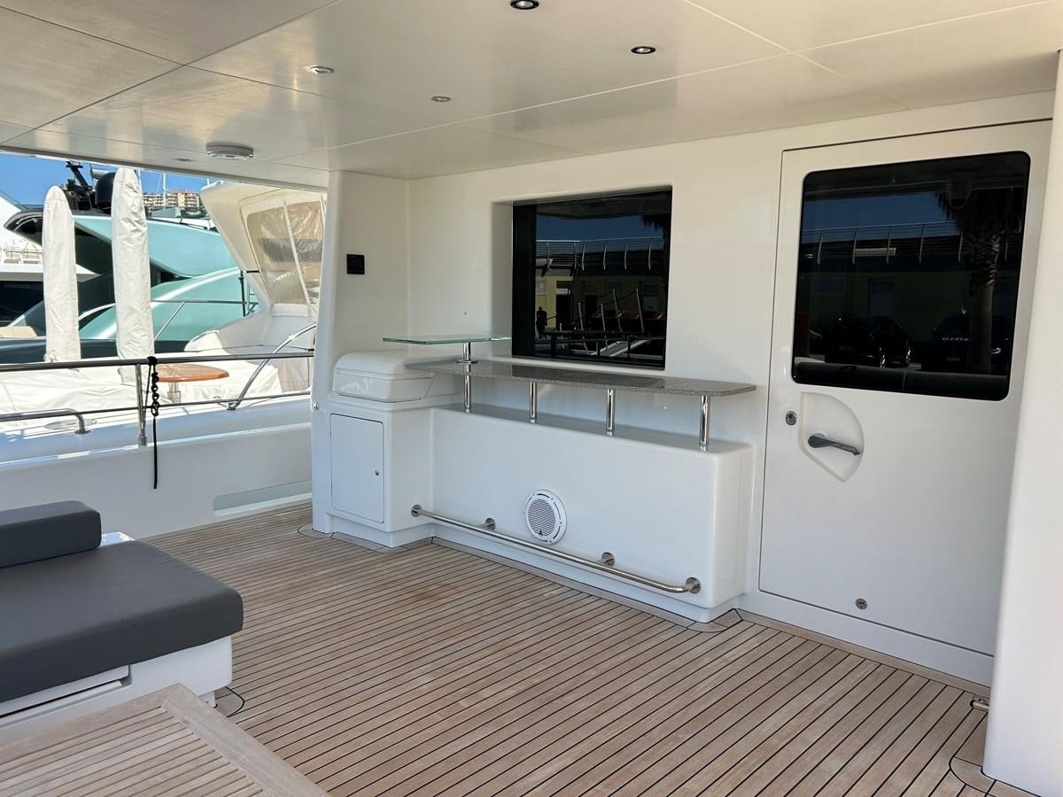 a room with a large window and a tv on the wall aboard YES Yacht for Sale