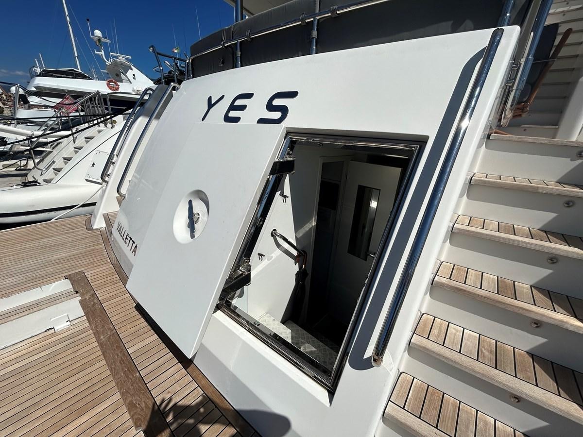 a large white boat with a window aboard YES Yacht for Sale