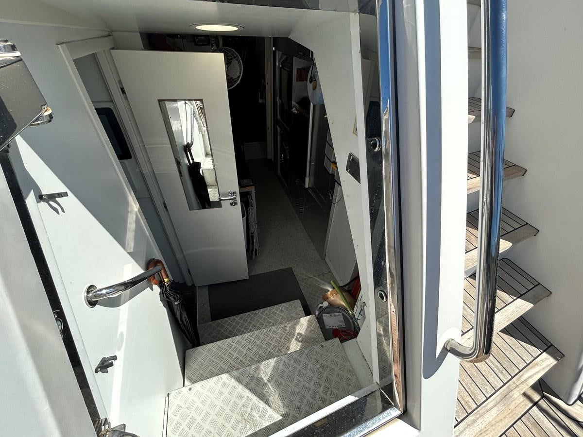 a hallway with a glass door aboard YES Yacht for Sale