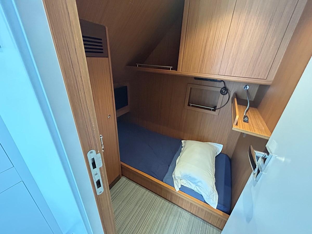 a room with a bed and a desk aboard YES Yacht for Sale