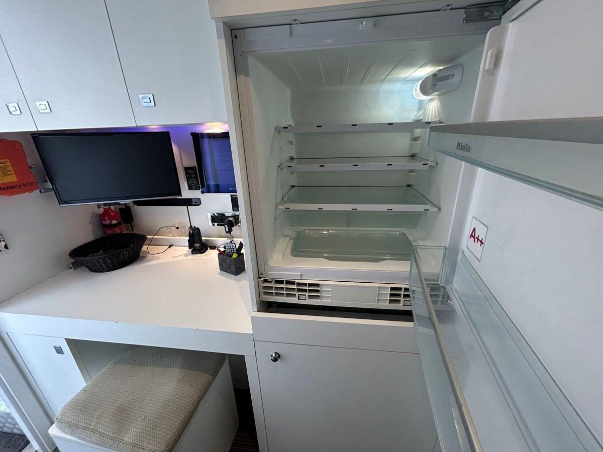 a white refrigerator in a kitchen aboard YES Yacht for Sale