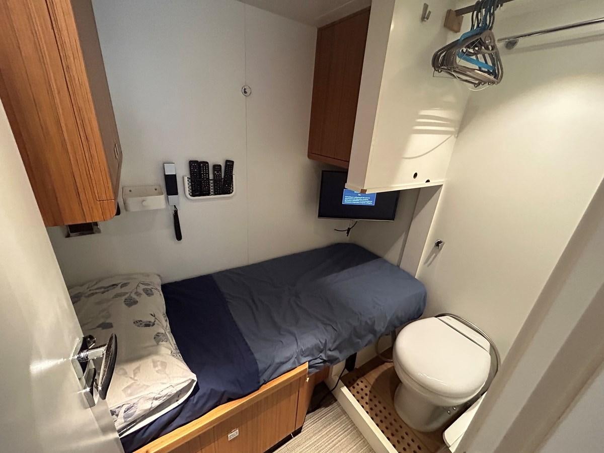 a small bedroom with a bed aboard YES Yacht for Sale