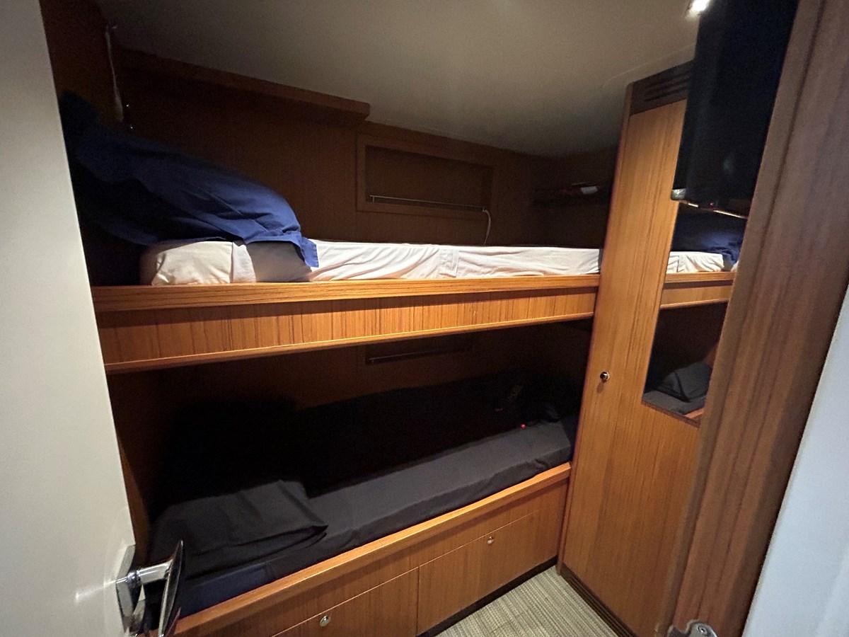 a bunk bed with a black pillow aboard YES Yacht for Sale