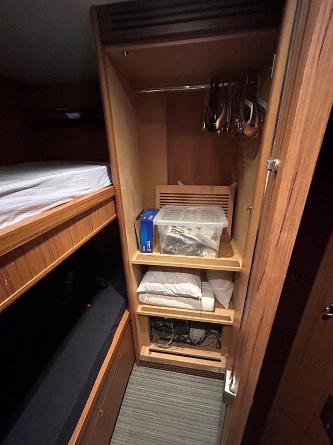 a closet with a shelf and a shelf with objects on it aboard YES Yacht for Sale