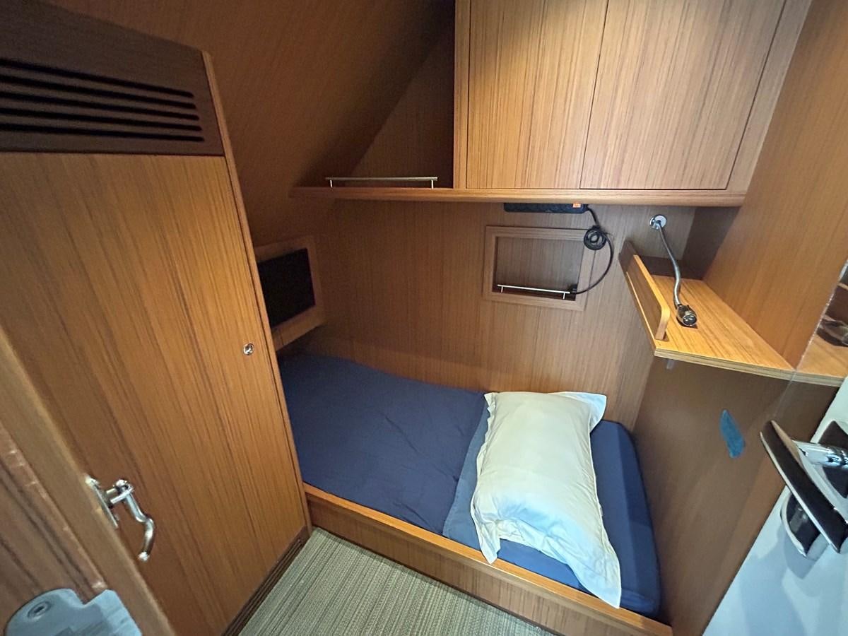 a room with a bed and a sink aboard YES Yacht for Sale