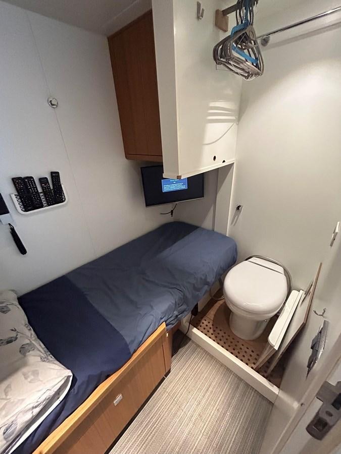 a small bedroom with a bed aboard YES Yacht for Sale