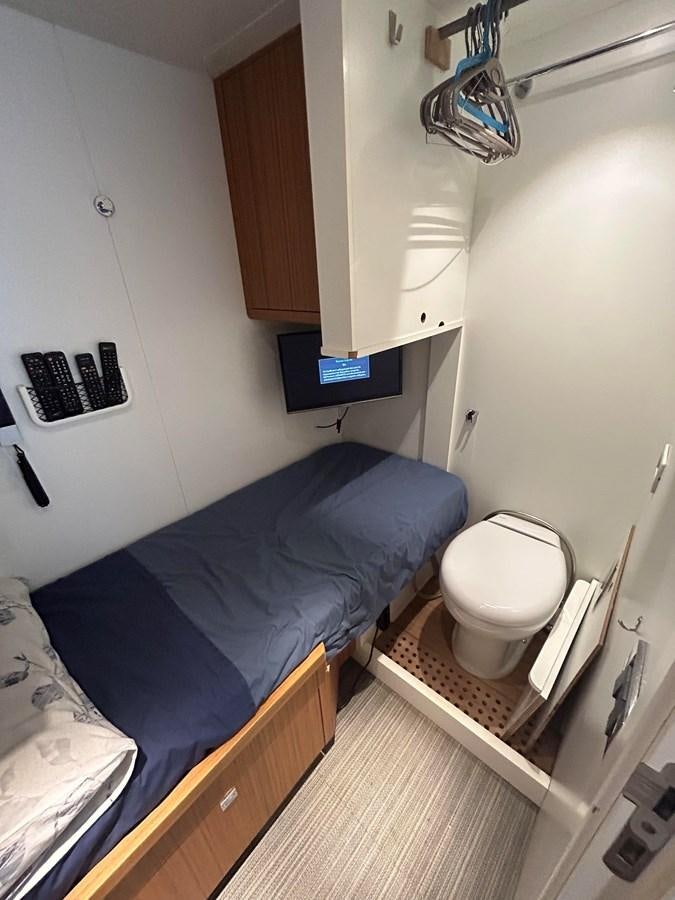 a small bedroom with a bed aboard YES Yacht for Sale