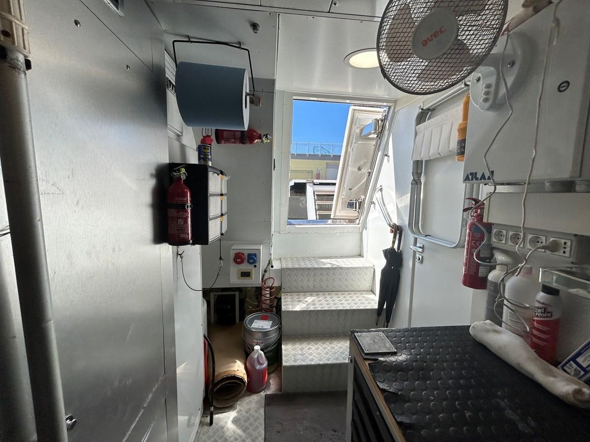 a small kitchen with a large window aboard YES Yacht for Sale