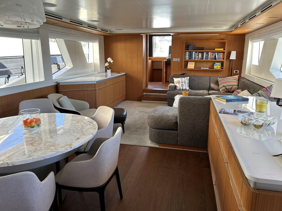 a living room with a couch and a table aboard YES Yacht for Sale
