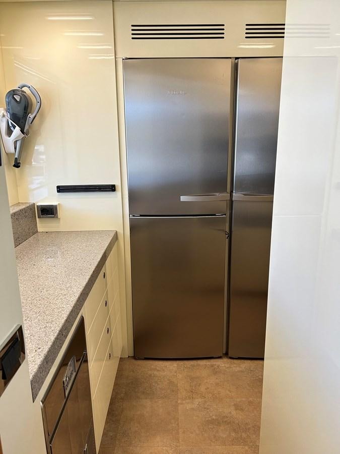 a kitchen with stainless steel appliances aboard YES Yacht for Sale