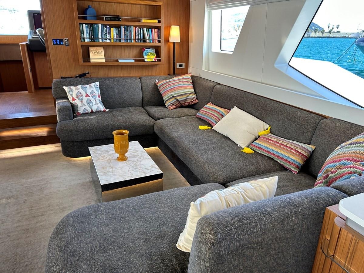 a living room with a couch and a coffee table aboard YES Yacht for Sale