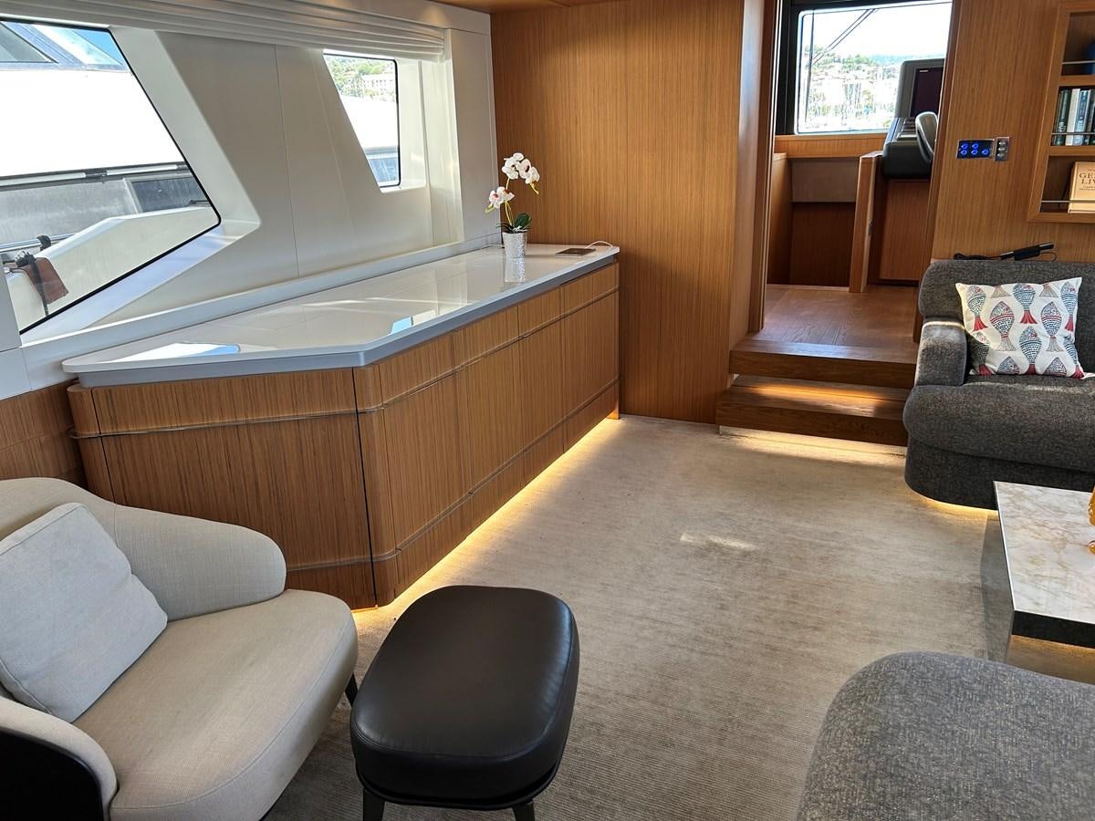 a living room with a large window aboard YES Yacht for Sale