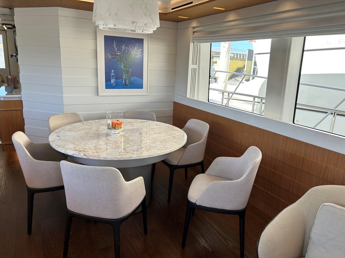 a table with chairs around it aboard YES Yacht for Sale