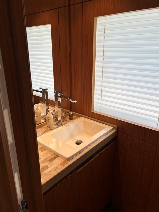 a bathroom with a sink and a window aboard YES Yacht for Sale