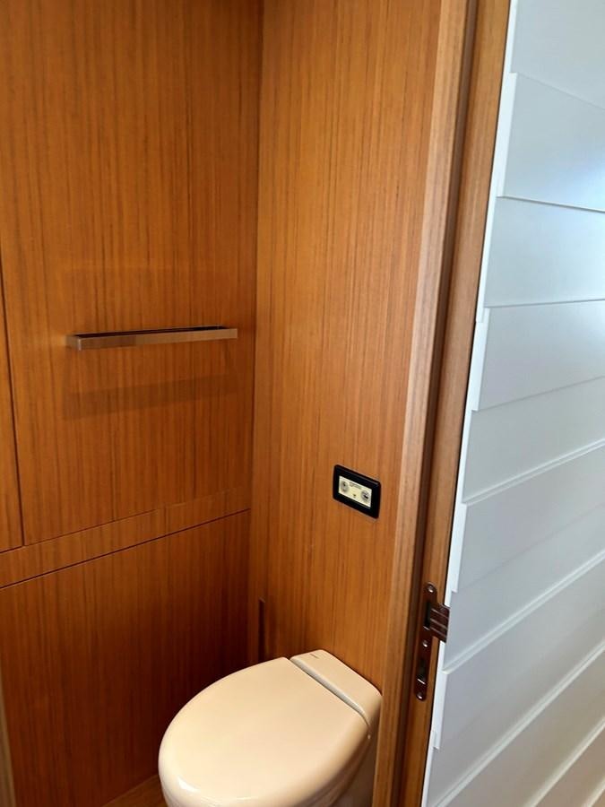 a wooden door with a toilet aboard YES Yacht for Sale