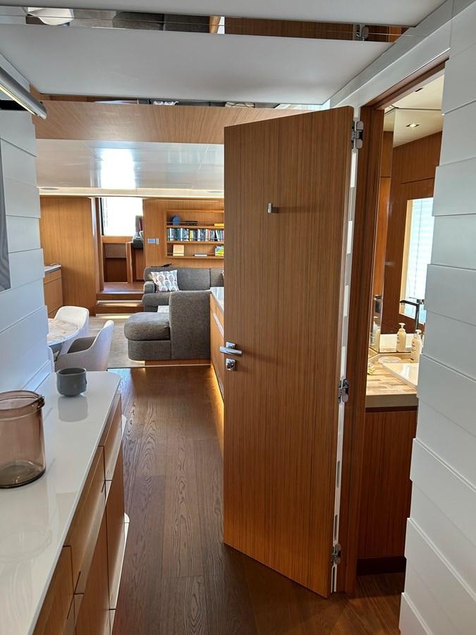 a room with a wood door and a couch aboard YES Yacht for Sale