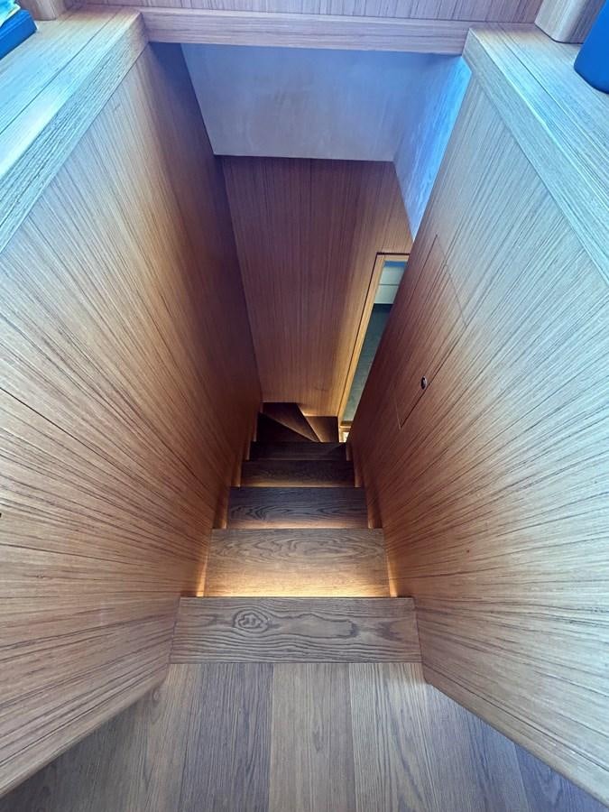 a wooden staircase with a wood floor aboard YES Yacht for Sale