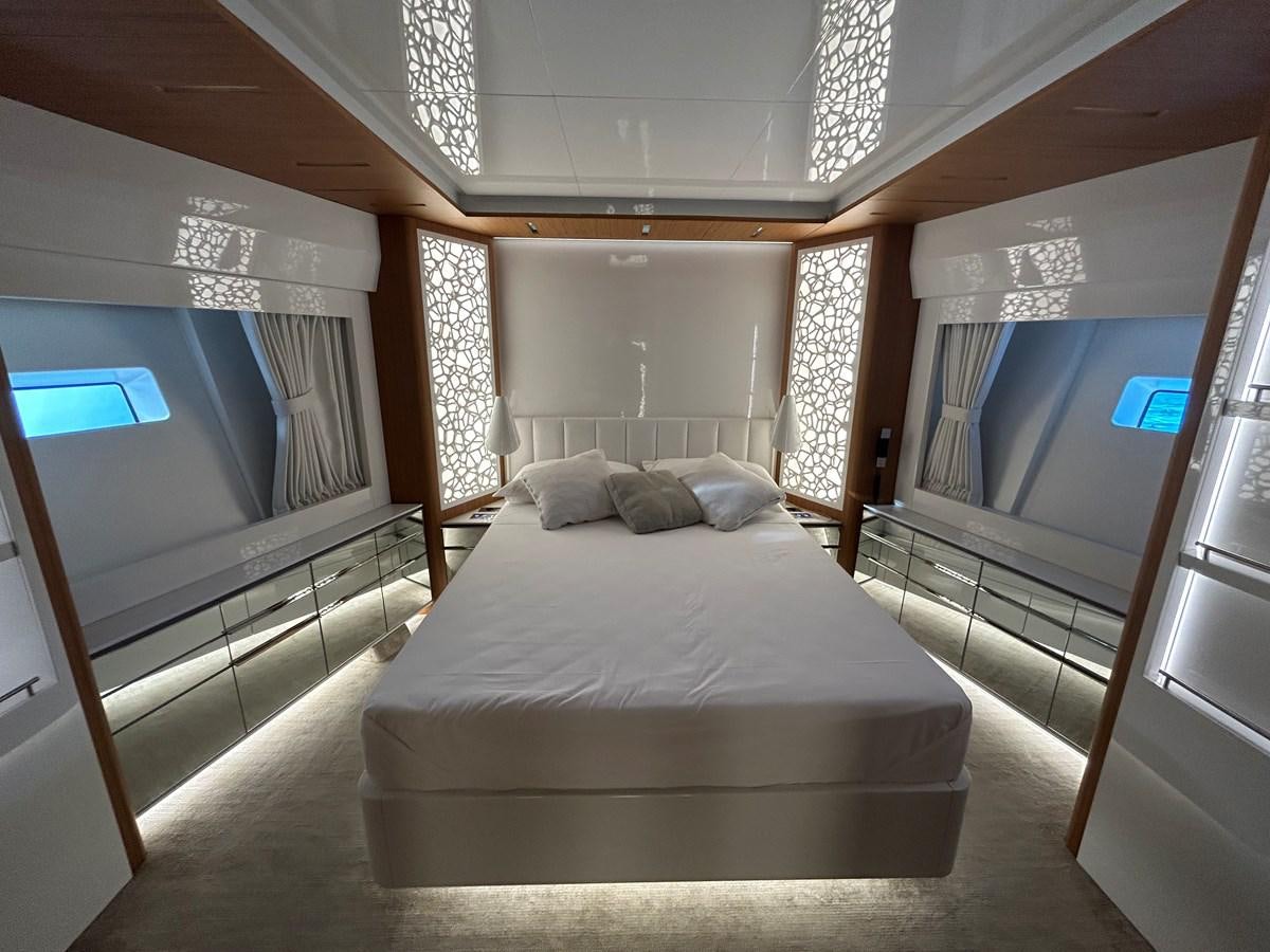 a room with a bed and a television aboard YES Yacht for Sale