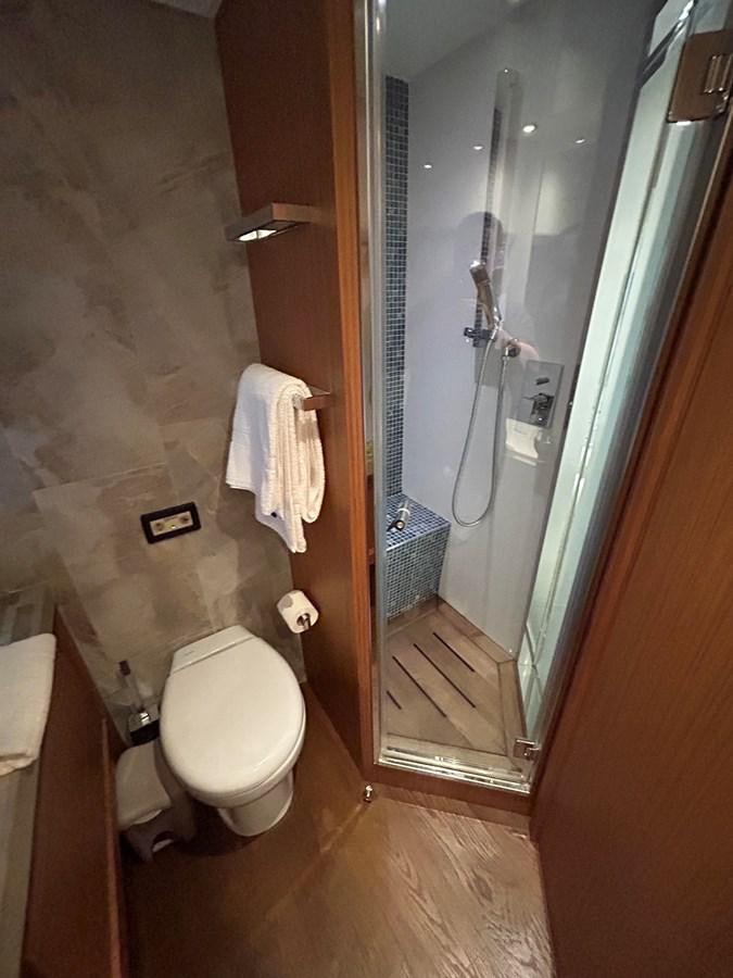 a bathroom with a glass shower aboard YES Yacht for Sale