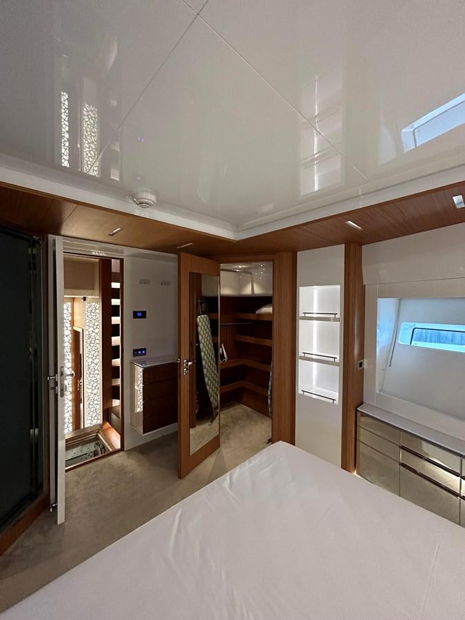 a room with a bed and a closet aboard YES Yacht for Sale