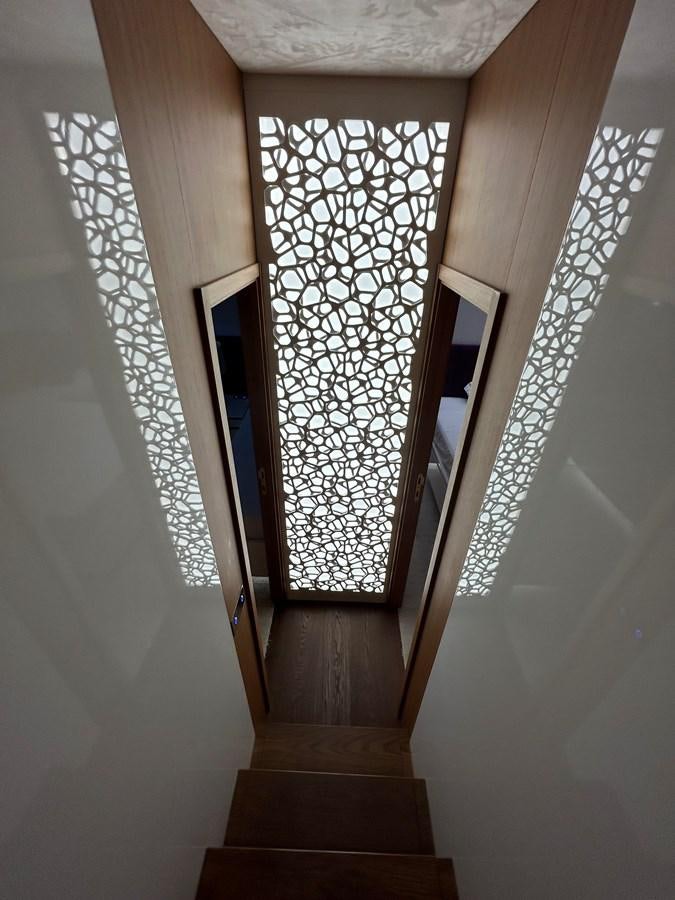 a hallway with a glass wall aboard YES Yacht for Sale