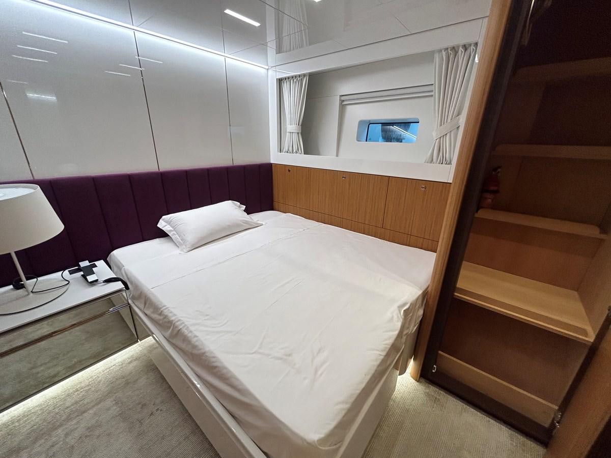 a room with a bed and a window aboard YES Yacht for Sale