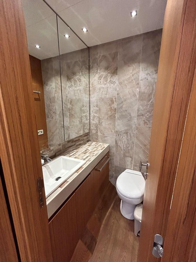 a bathroom with a toilet and sink aboard YES Yacht for Sale