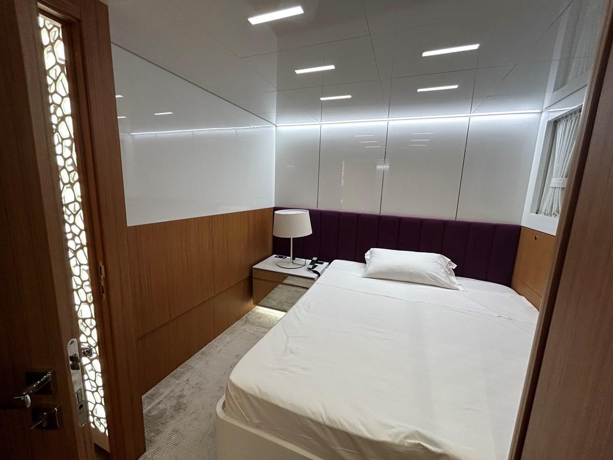 a room with a bed and a window aboard YES Yacht for Sale