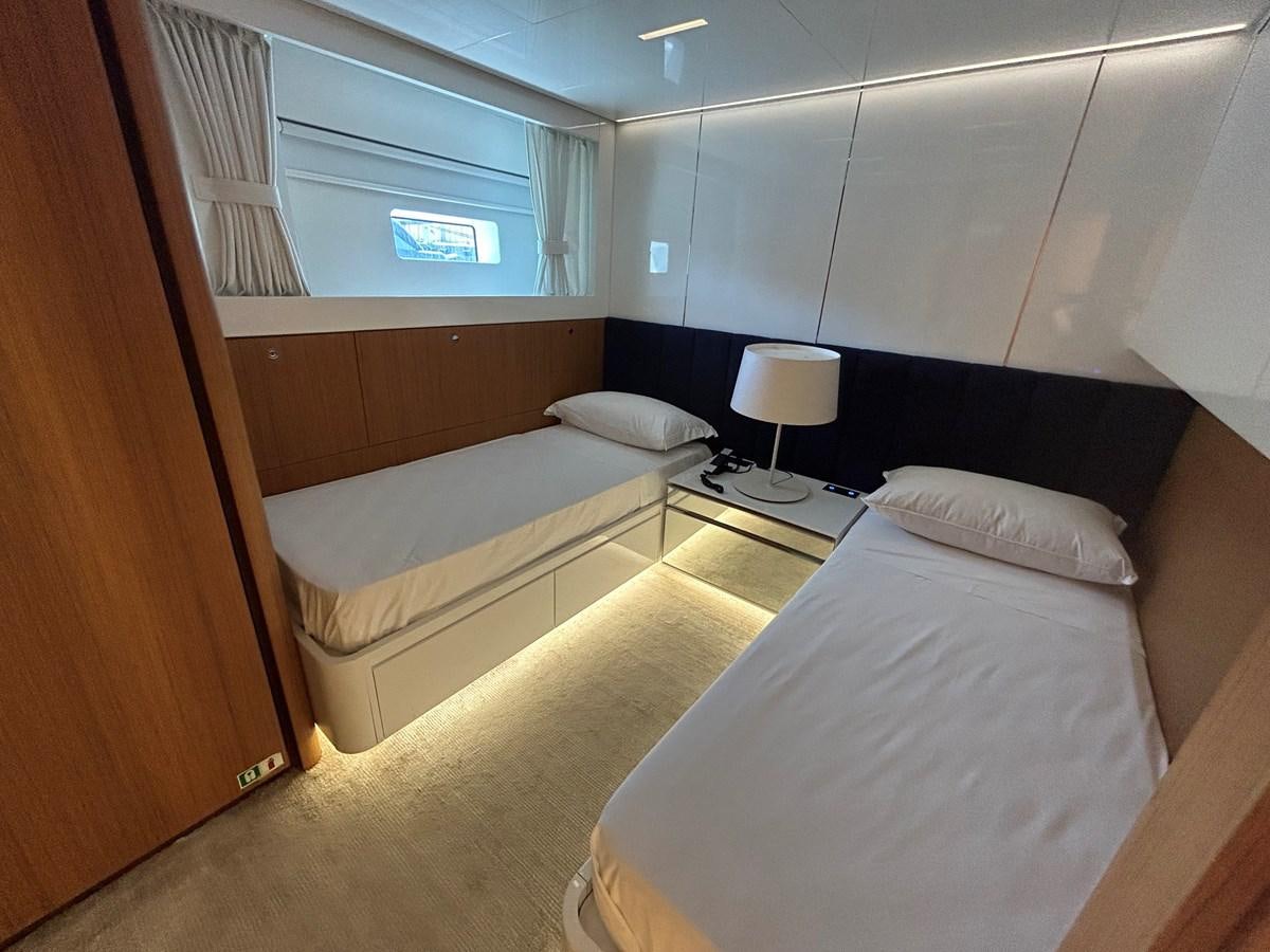 a room with two beds aboard YES Yacht for Sale