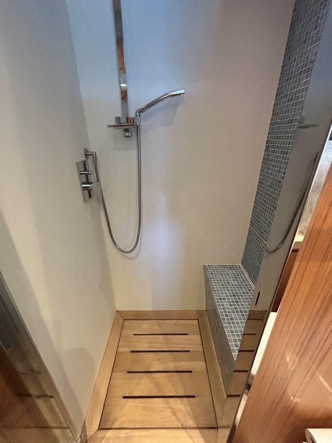 a wooden staircase with a metal railing aboard YES Yacht for Sale