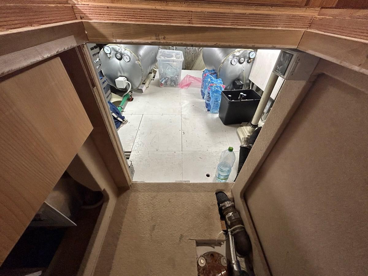 a kitchen with a sink and a garbage can aboard YES Yacht for Sale