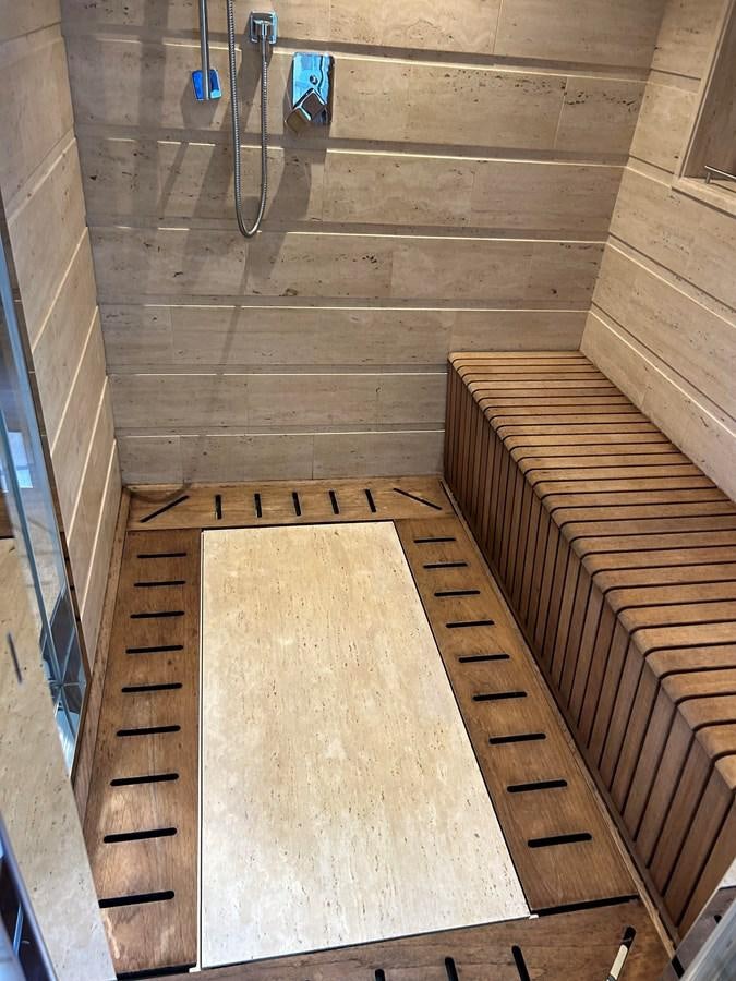 a wooden staircase with a metal railing aboard YES Yacht for Sale