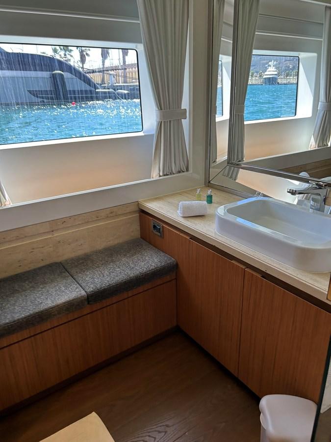 a bathroom with a sink and a window aboard YES Yacht for Sale