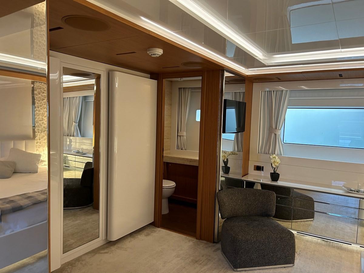 a room with a chair and a tv on the wall aboard YES Yacht for Sale