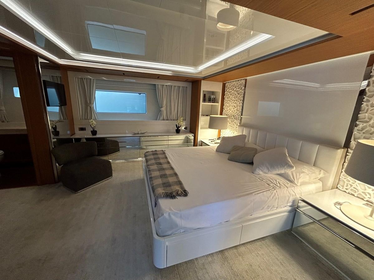 a room with a bed and a tv aboard YES Yacht for Sale