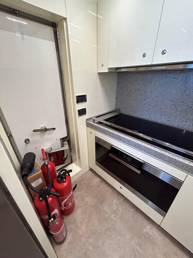 a kitchen with a stove and cabinets aboard YES Yacht for Sale