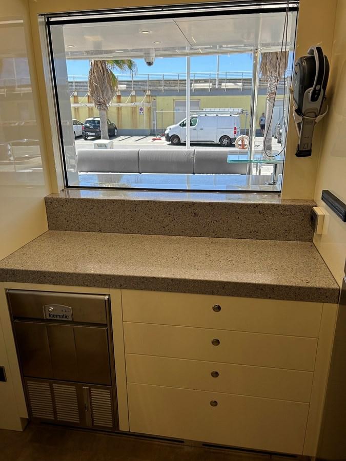 a window with a view of a parking lot and cars aboard YES Yacht for Sale