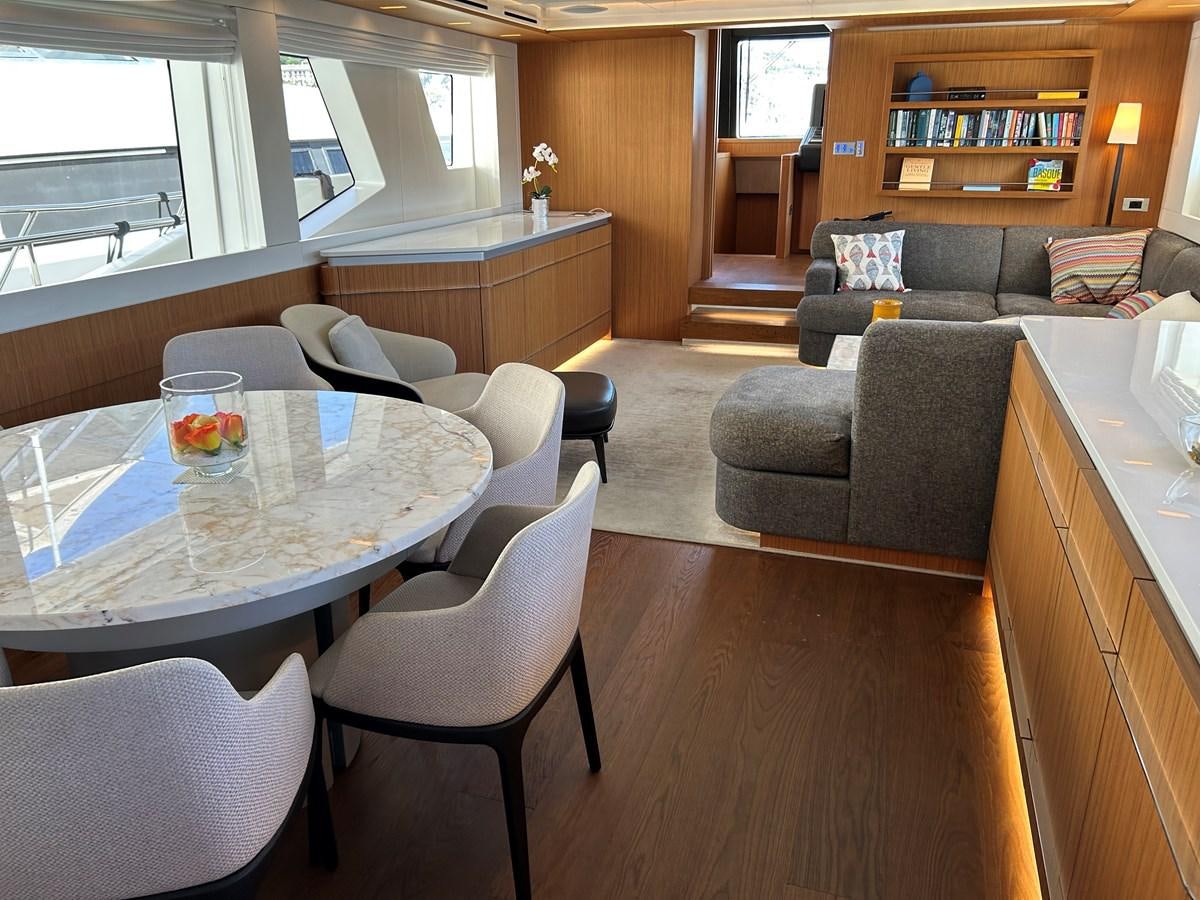 a living room with a couch and a table aboard YES Yacht for Sale