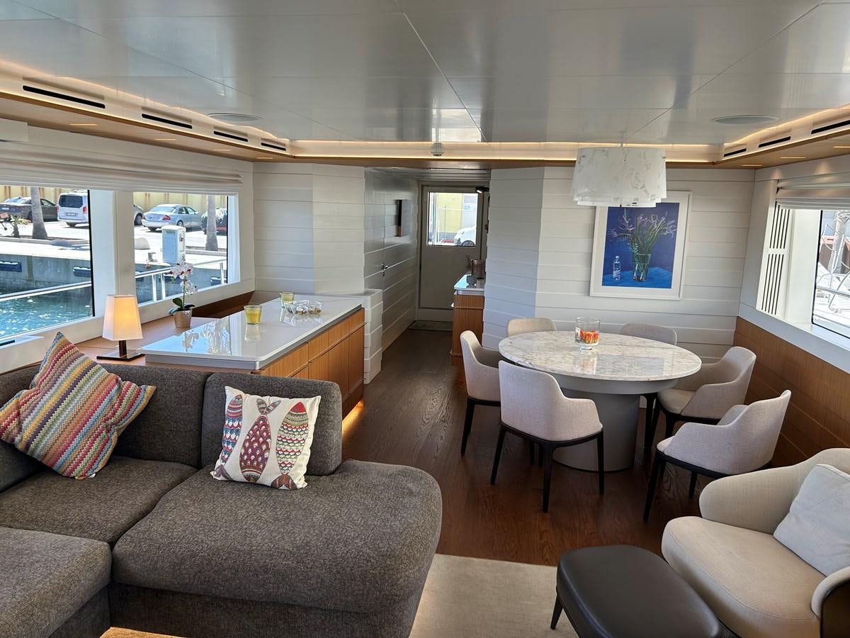 a living room with a couch and a table aboard YES Yacht for Sale